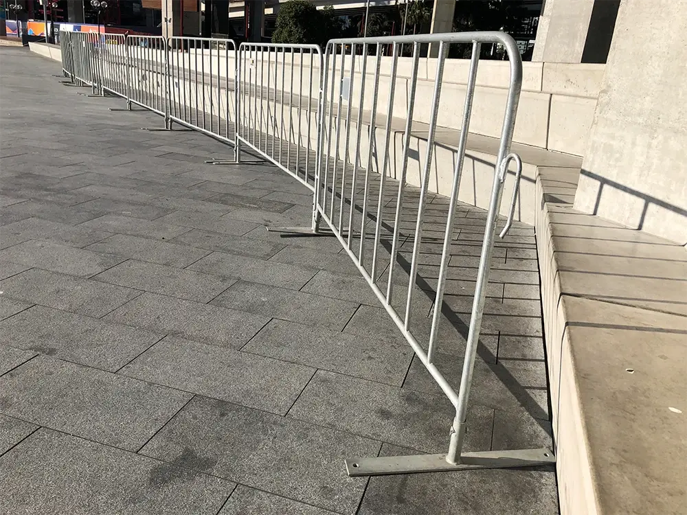 Long run of crowd control barriers linked along a pedestrian route