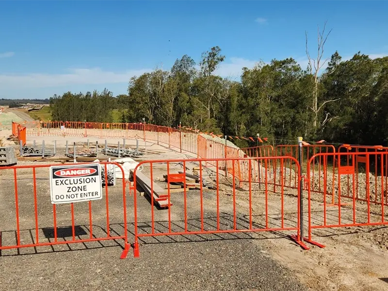 Orange steel crowd barriers marking a restricted work area