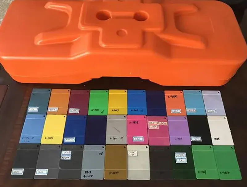Colour sample cards beside an orange temporary fence base