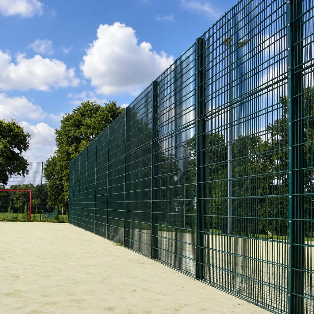 Tall twin wire fence along the edge of an outdoor sports court