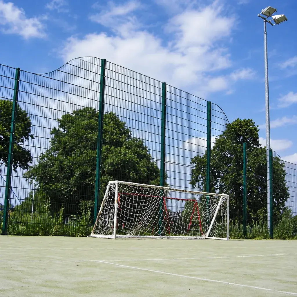 Tall twin wire sports fencing behind a football goal