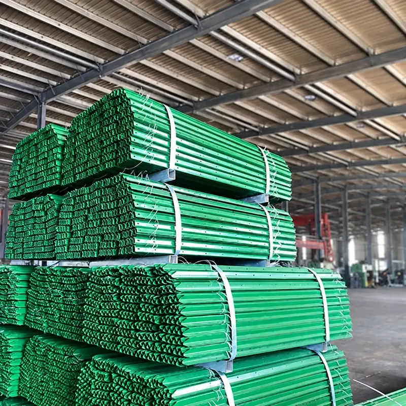 Bundled green steel T-posts with studs and anchor plates