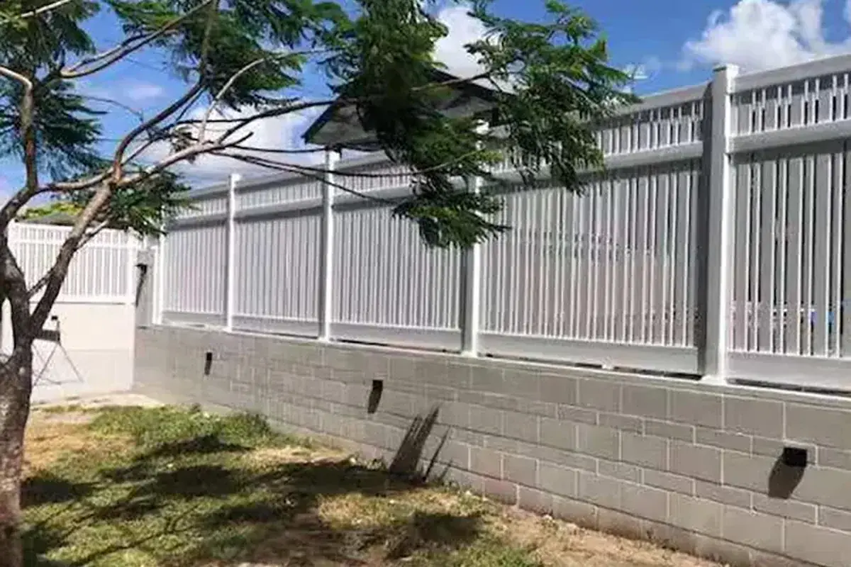 White capped posts along a garden fence