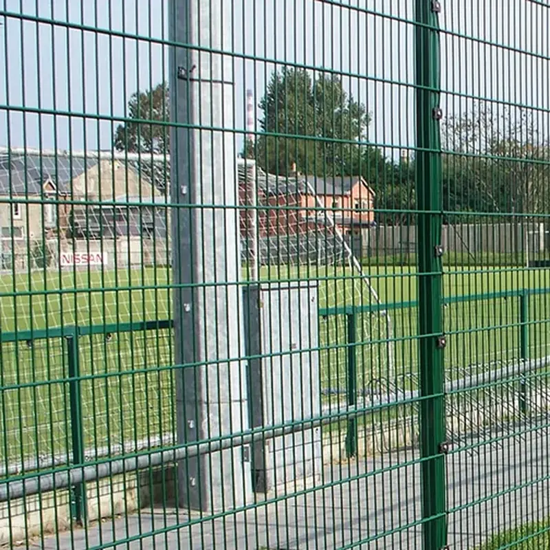 Green steel posts between welded mesh fence panels