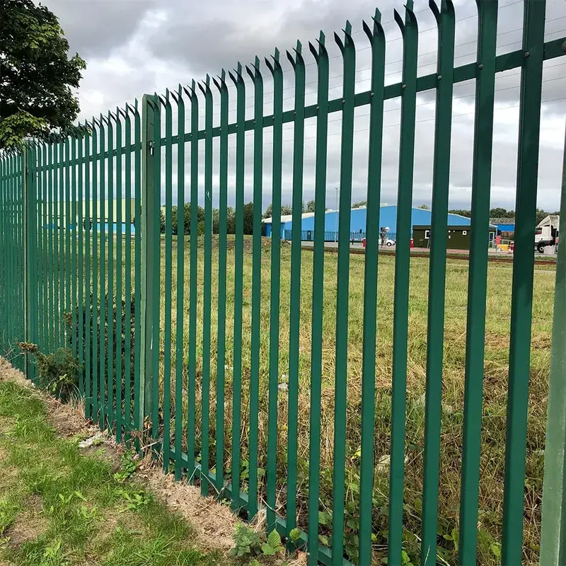 Green steel posts along a palisade fence run