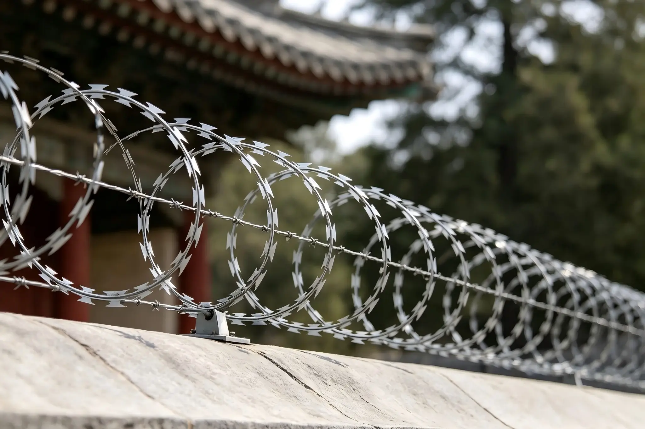 Razor wire topping along a masonry boundary wall