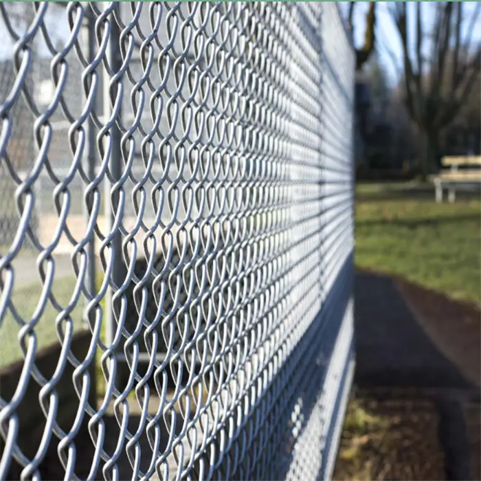 Silver galvanised chain link fence showing woven diamond mesh