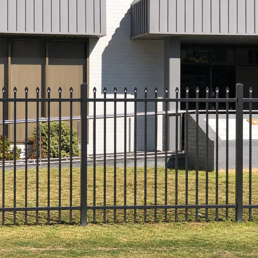 Black spear-top steel fence along a building frontage