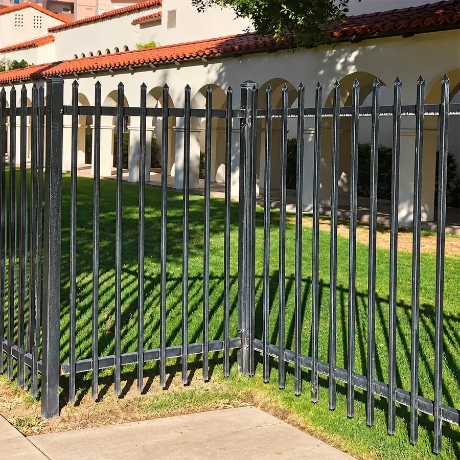 Steel picket fence turning a corner beside a footpath