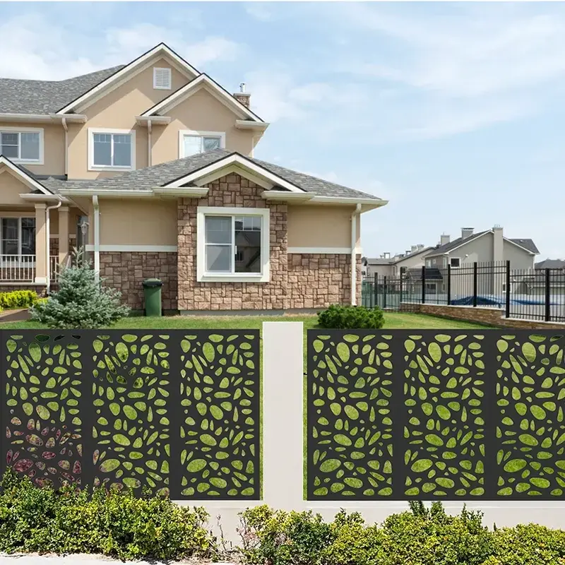 Decorative laser-cut metal fence panels along a residential boundary