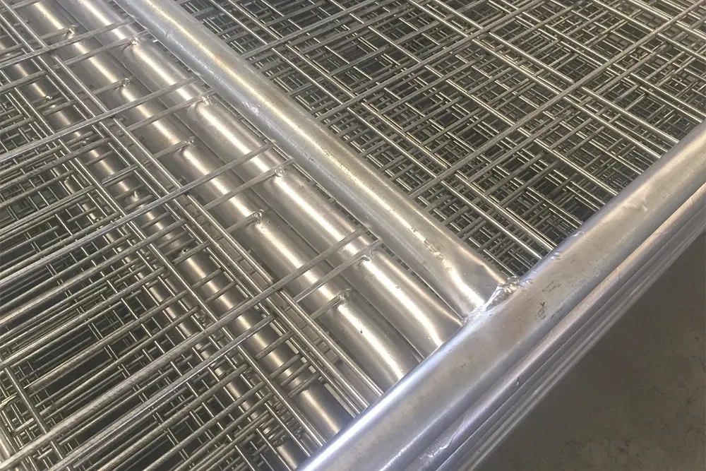 Close view of galvanised wire mesh infill attached to a tubular gate frame