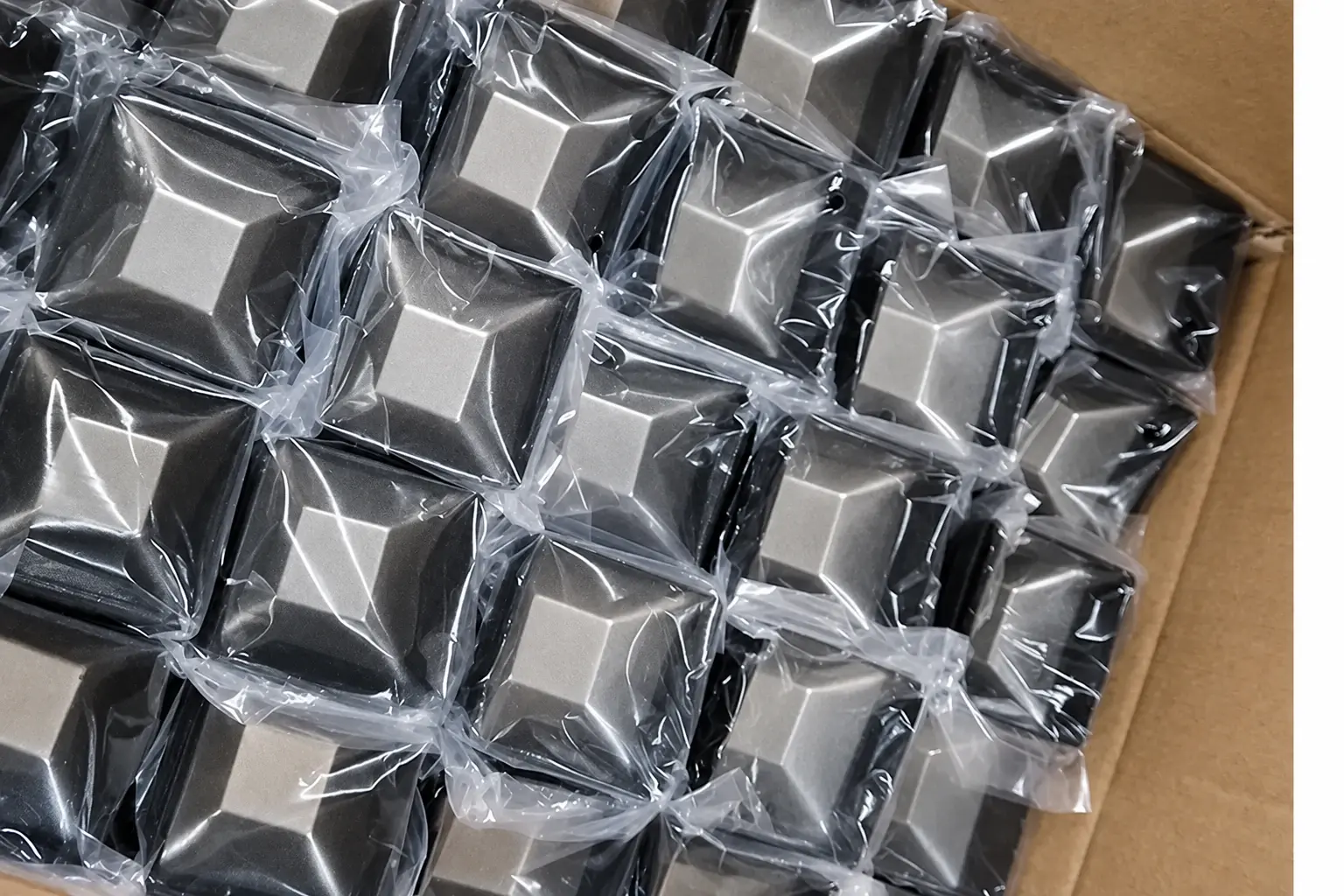 Individually bagged black fence post caps arranged together