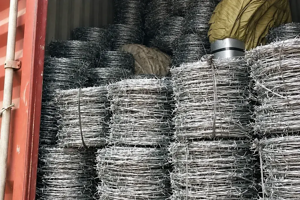 Wire fence rolls stacked and wrapped inside a shipping container