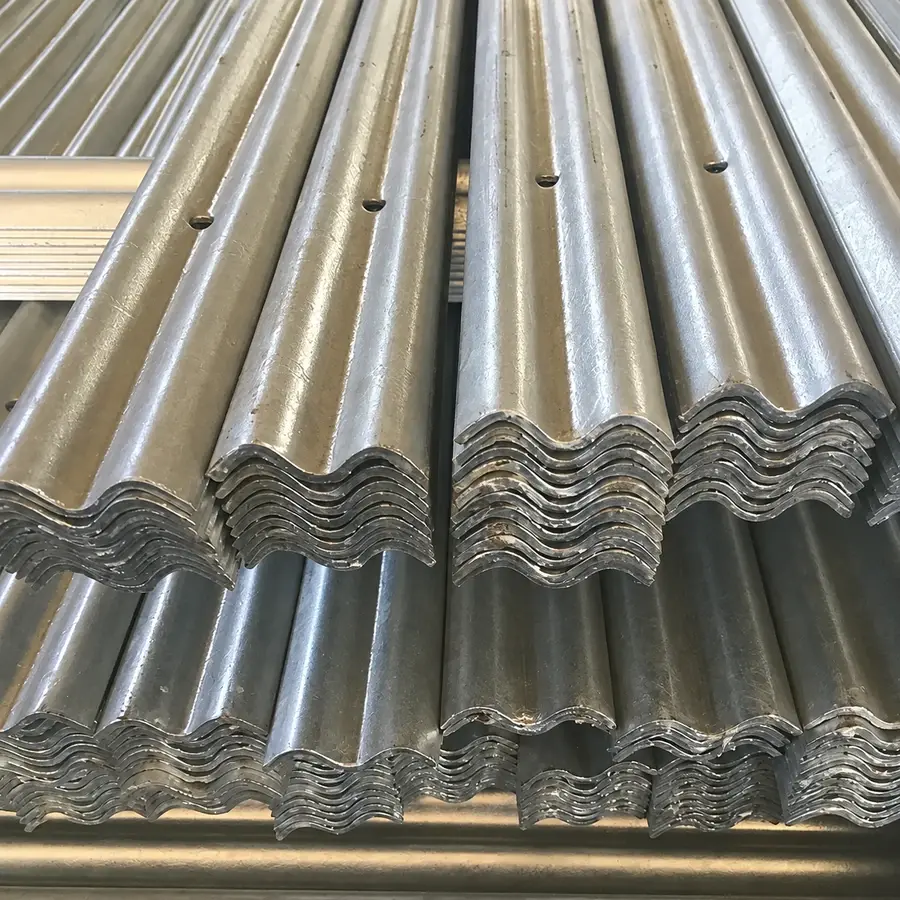 Stacked formed steel pale sections showing their profile and holes