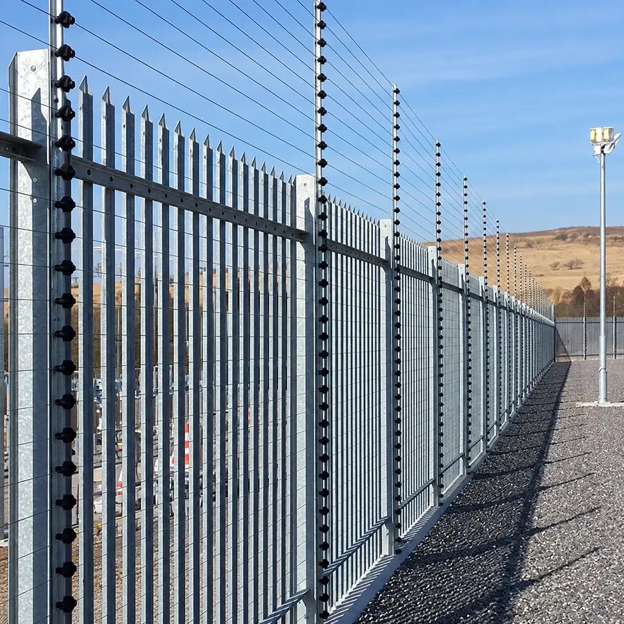 Steel palisade fencing around an industrial enclosure