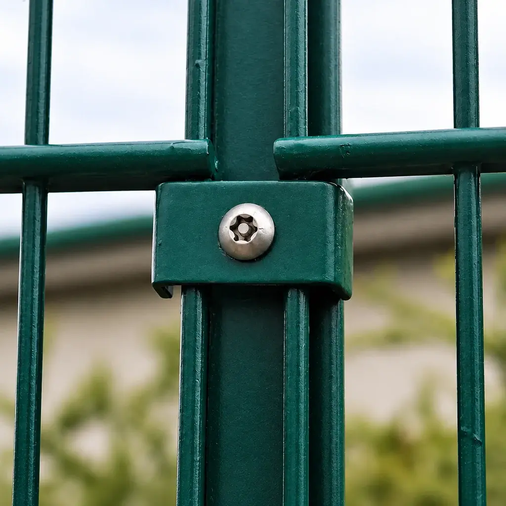 Pin-in-star security screw securing a green mesh clip to a fence post