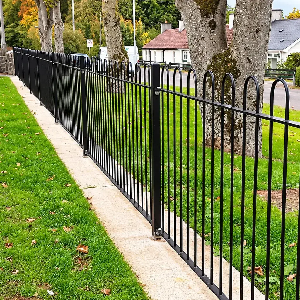 Black bow-top railings beside a path and lawn