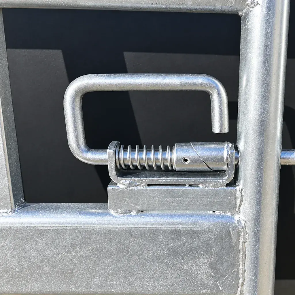 Spring-loaded metal latch fitted to a farm gate