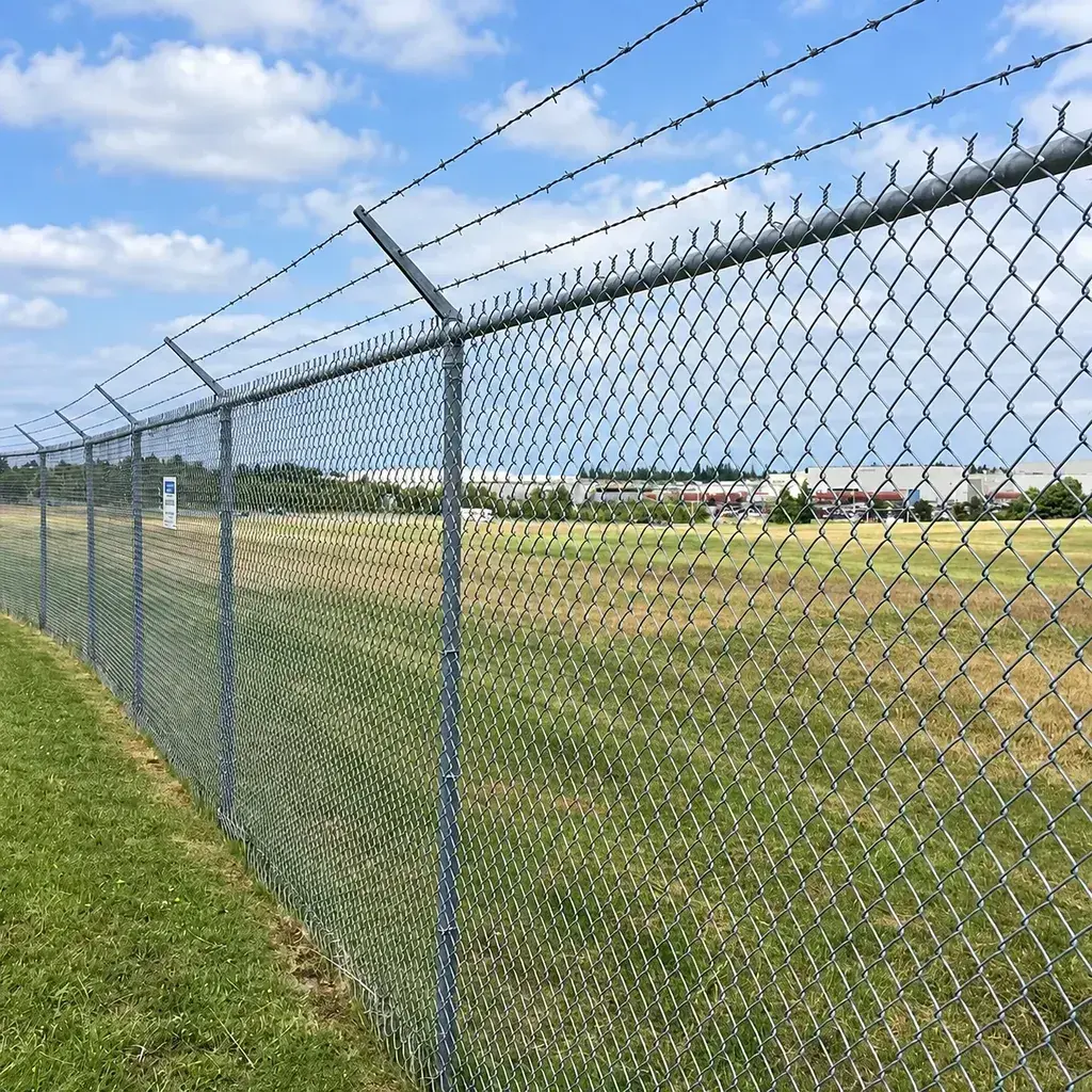 Galvanised chain-link fence with angled top extensions