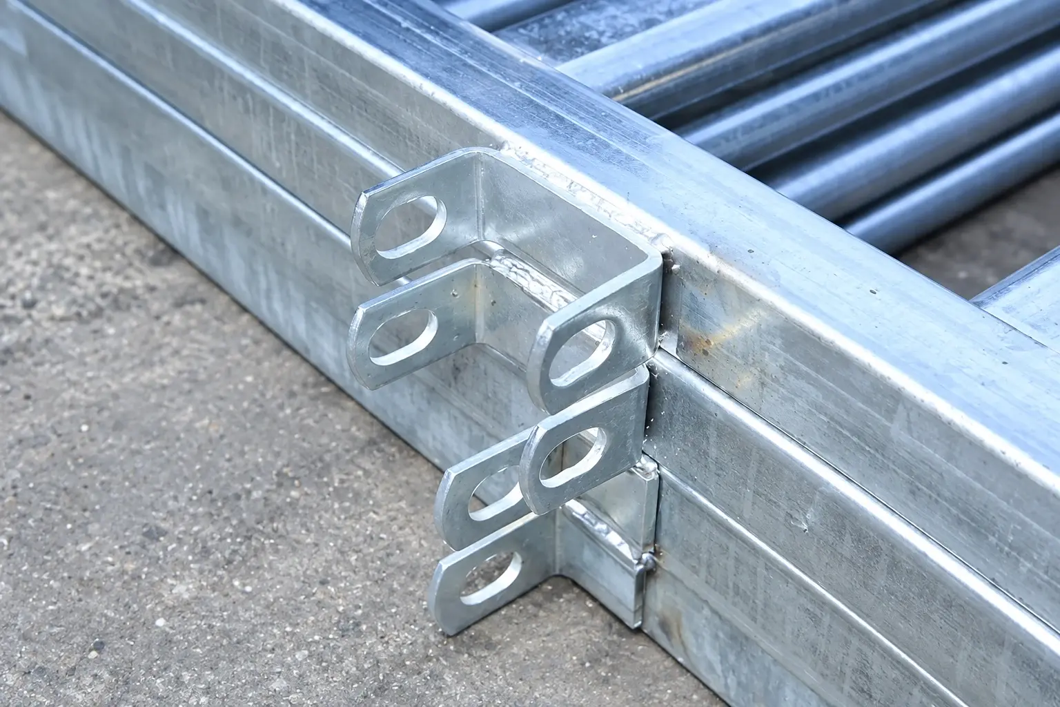 Galvanised fence members with welded connection brackets