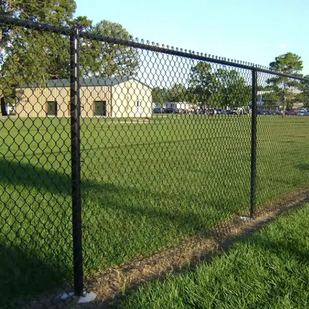 Dark coated chain link fence along a grass playing field