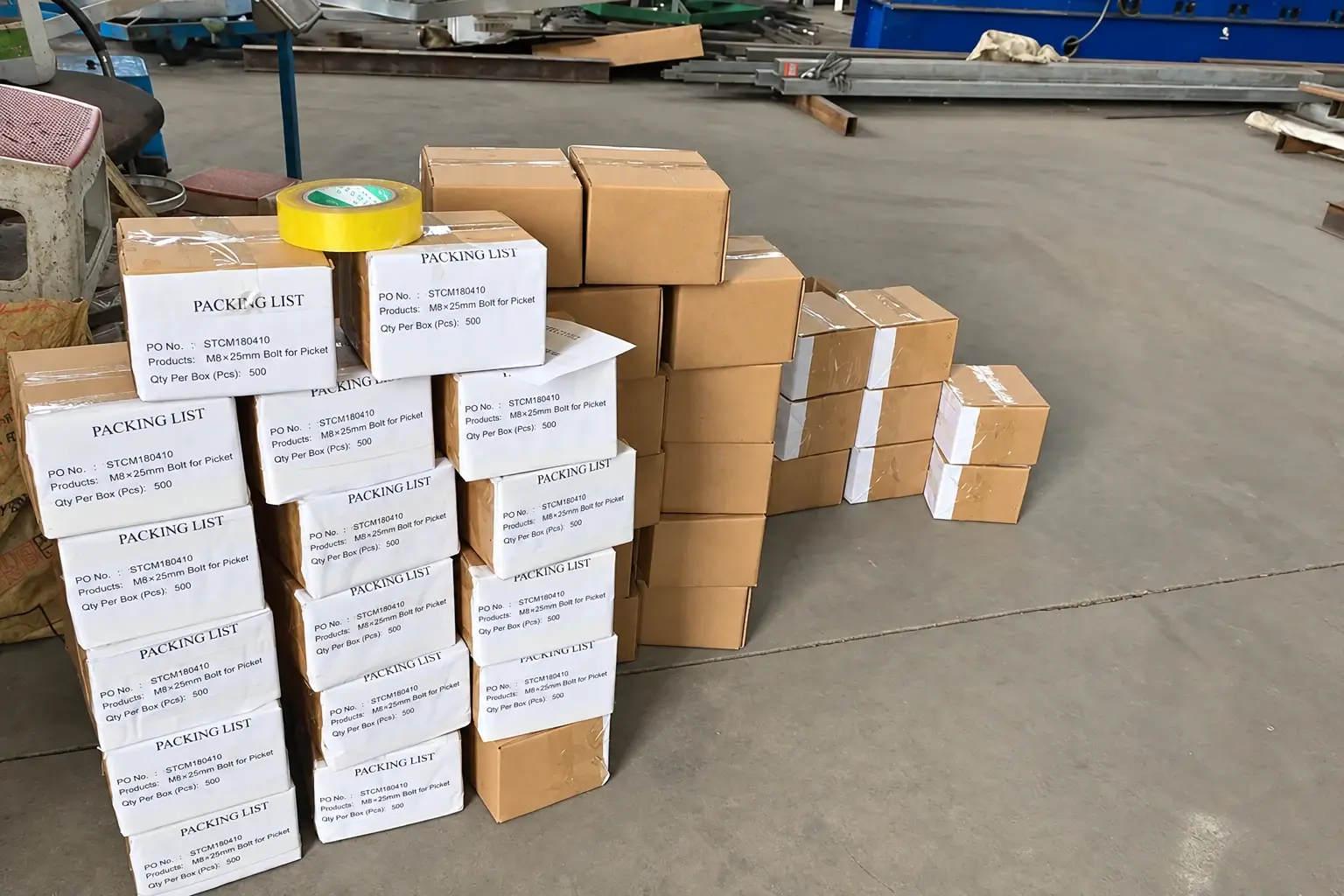 Cartons of fence fixing bolts with packing labels listing item references and quantities