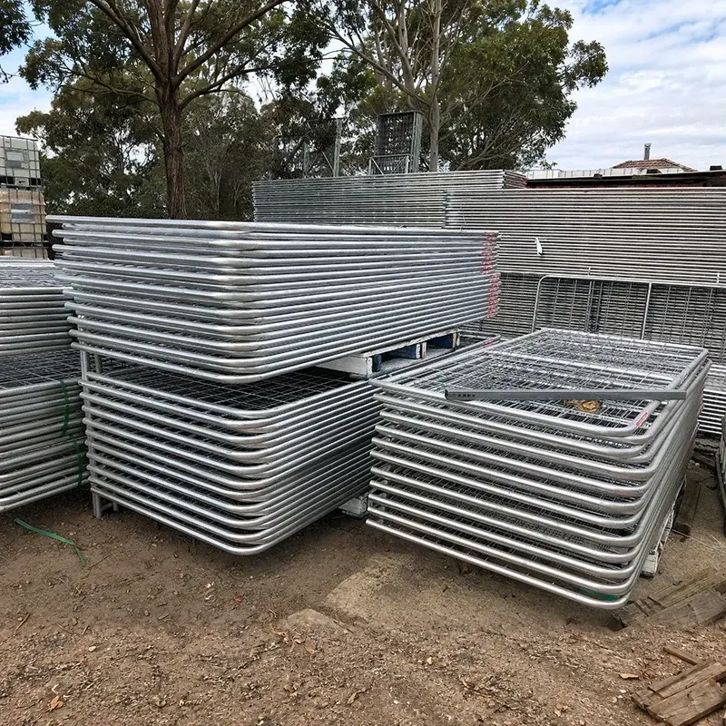 Galvanised farm gate leaves standing in a storage stack