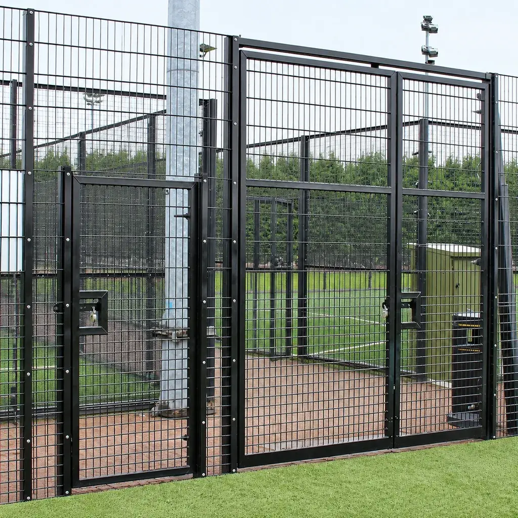 Gate and adjoining rebound fence panels at a sports court