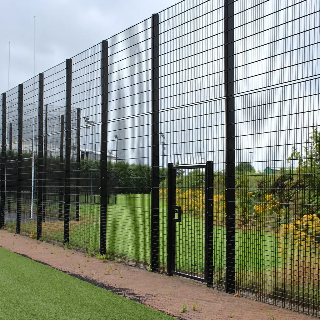 Rebound sports fence with tall upper panels beside a playing area