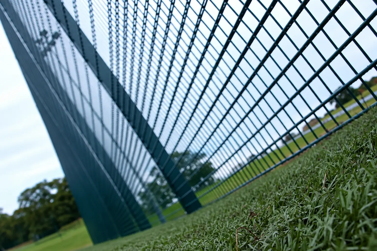 Court-side view of rebound fence mesh and support posts