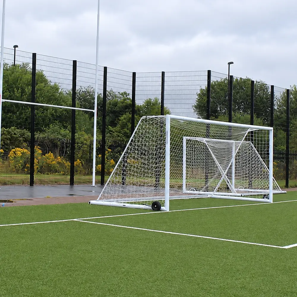 Tall rebound sports fencing enclosing a football pitch