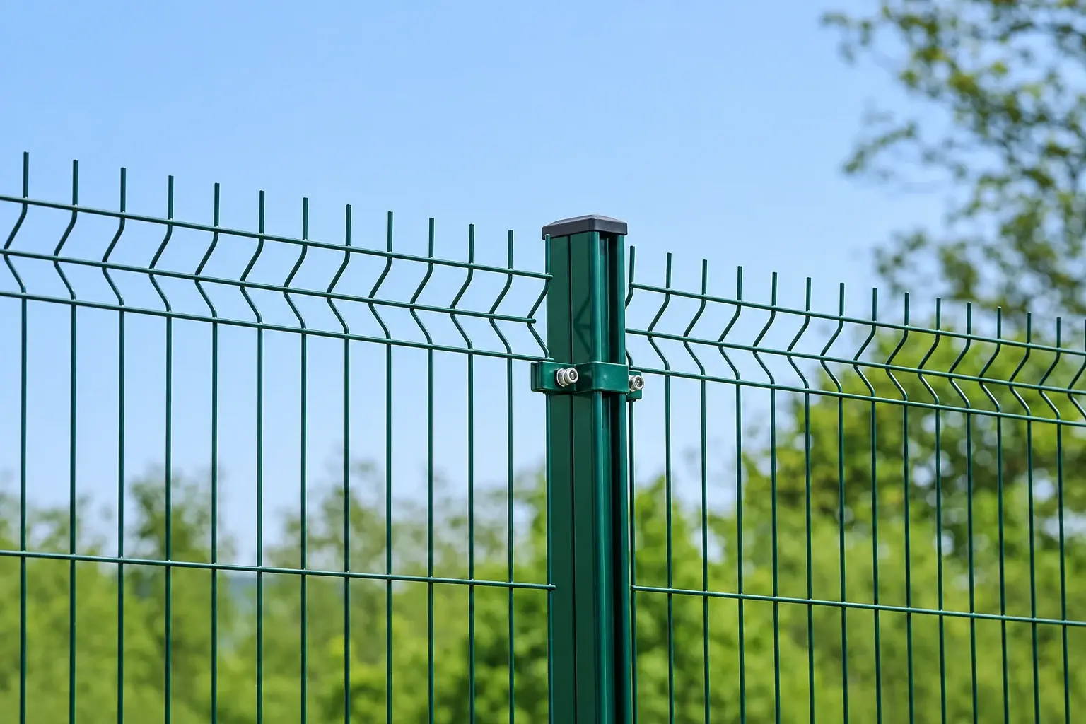 Green profiled mesh panels fixed to a square post with a metal clamp