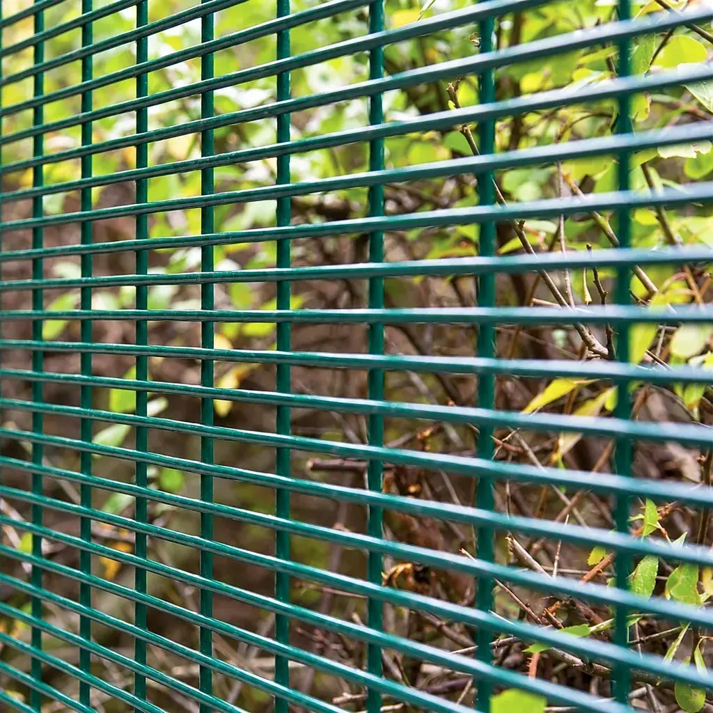 Close-up of narrow horizontal openings in green security mesh
