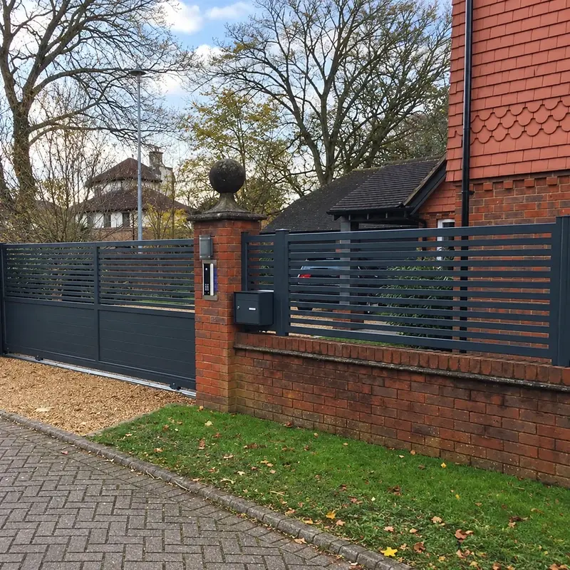 Dark aluminium sliding gate in a brick boundary