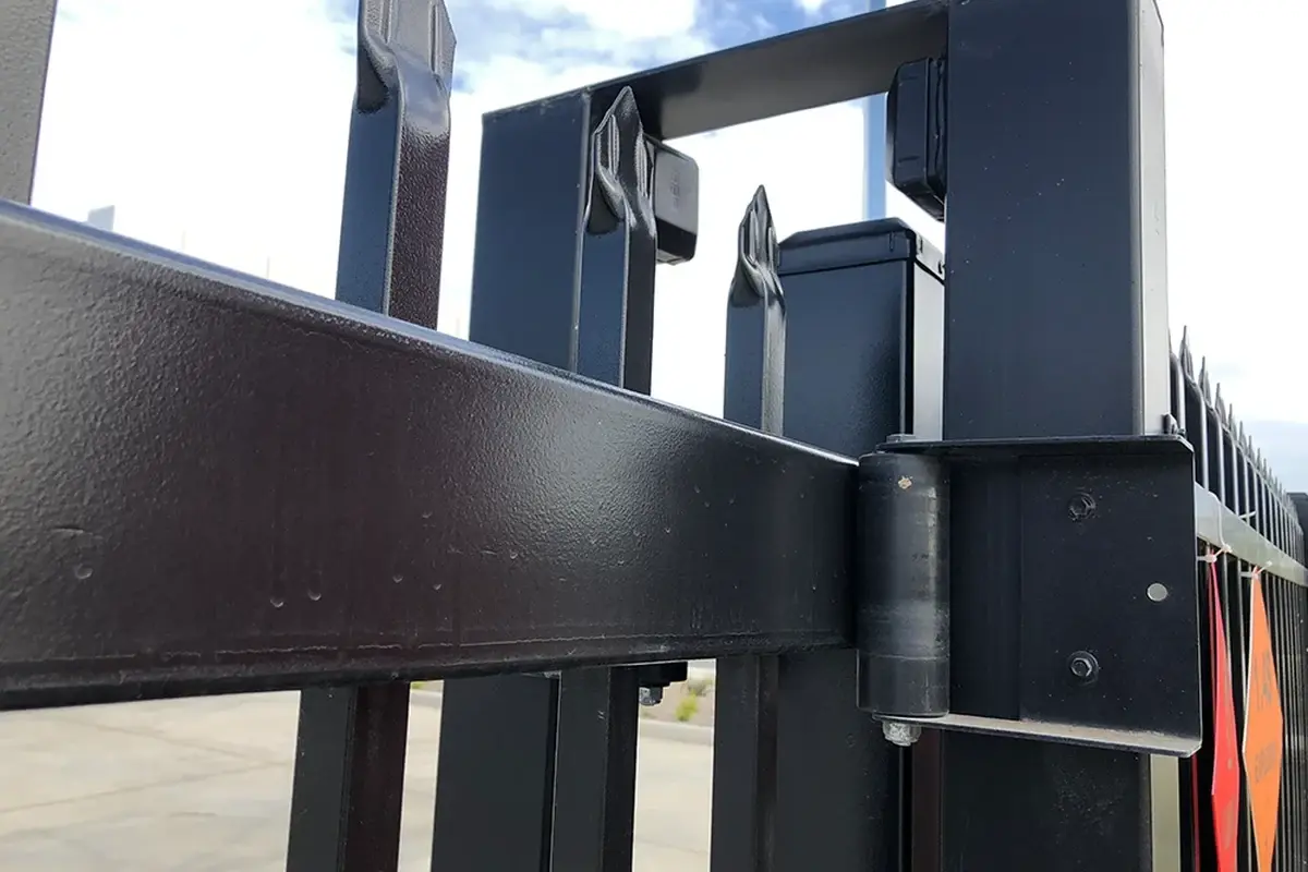 Upper guide rollers retaining a sliding gate frame