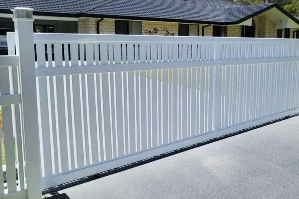 White sliding gate running beside a residential fence