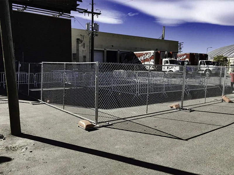 Temporary chain link fence panels closing an industrial yard