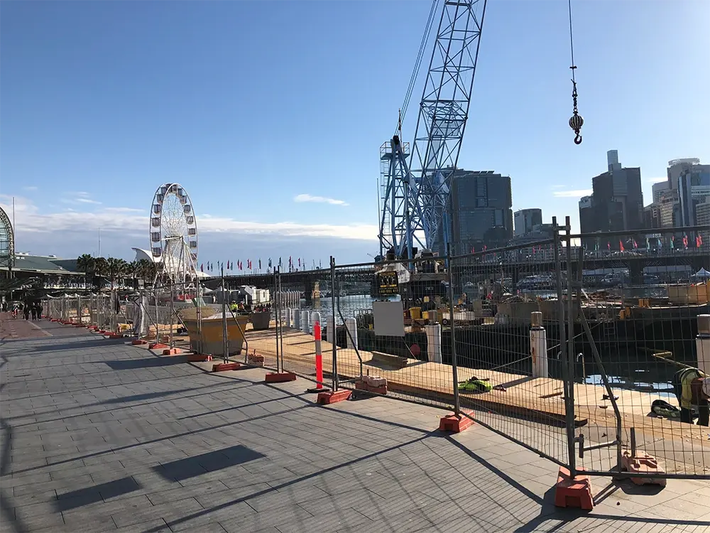 Temporary welded mesh fence following a city construction site boundary