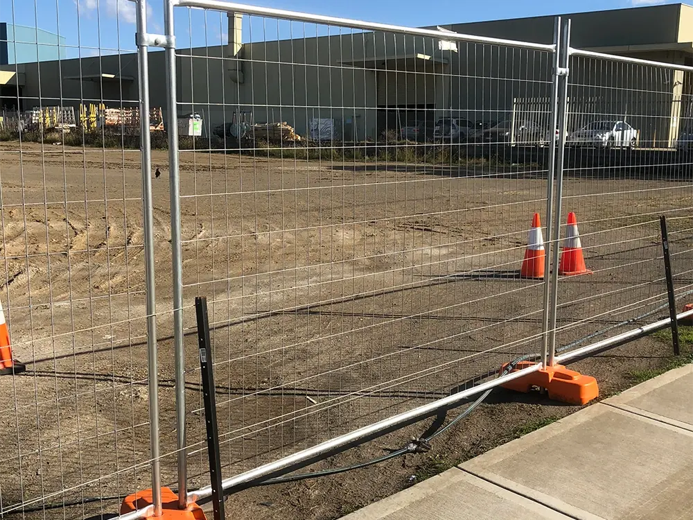 Temporary welded mesh fence along a building site boundary