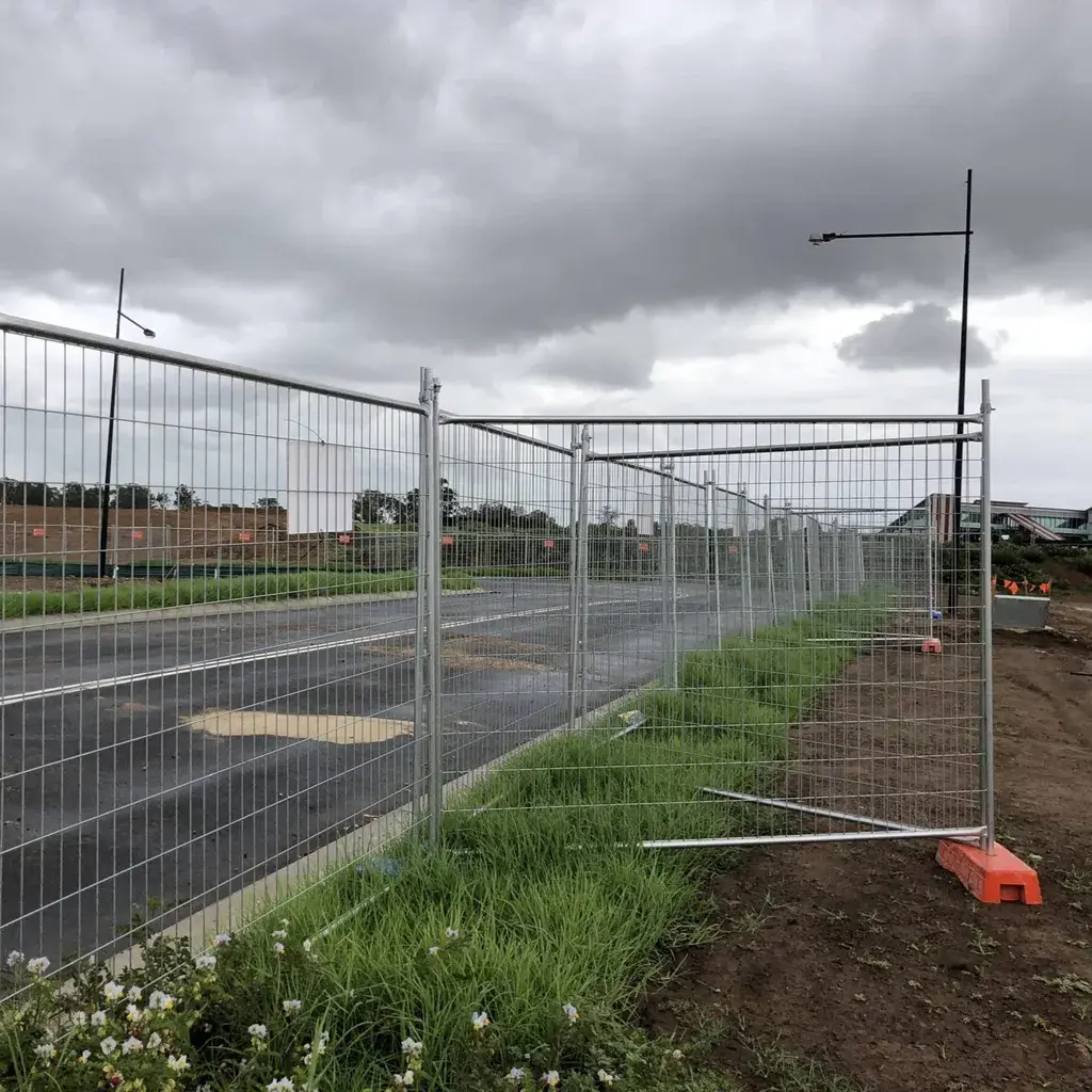 Temporary welded mesh fence and corner panel beside road works