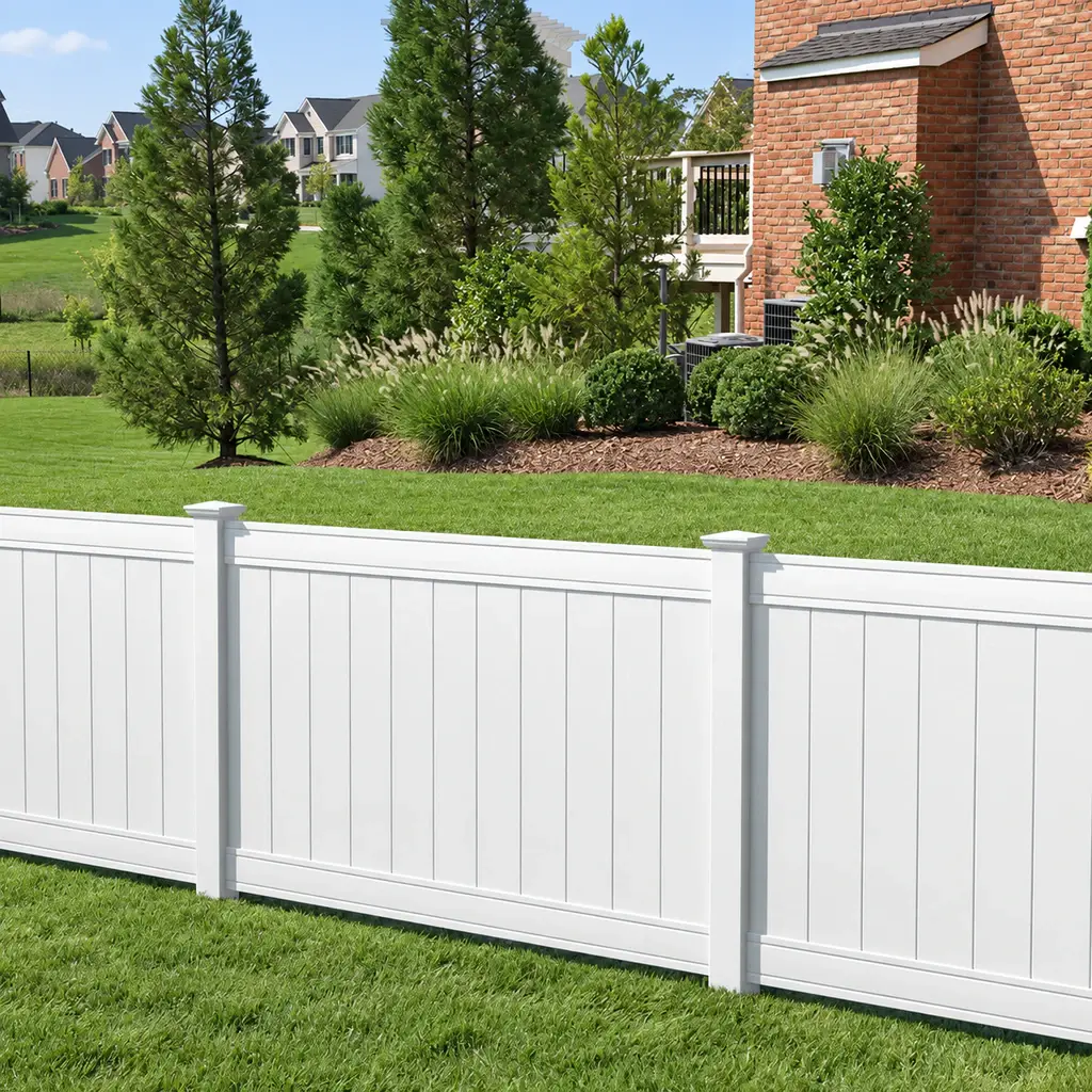 White full privacy PVC fence beside a lawn and house